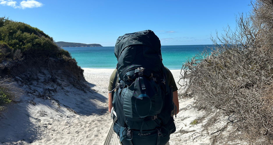 Hiker wearing Osprey Ariel Plus 70 at Waterloo Bay in Wilsons Promontory