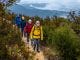 4 people walking with different colours of waterproof jacket