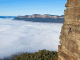 Monique Forrestier climbing a cliff overlooking the Blue Mountains