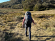 Girl walking through mountains wearing Osprey Aura AG