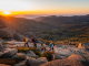 Group walking on top of a mountain wearing sustainable outdoor brands Patagonia and Cotopaxi